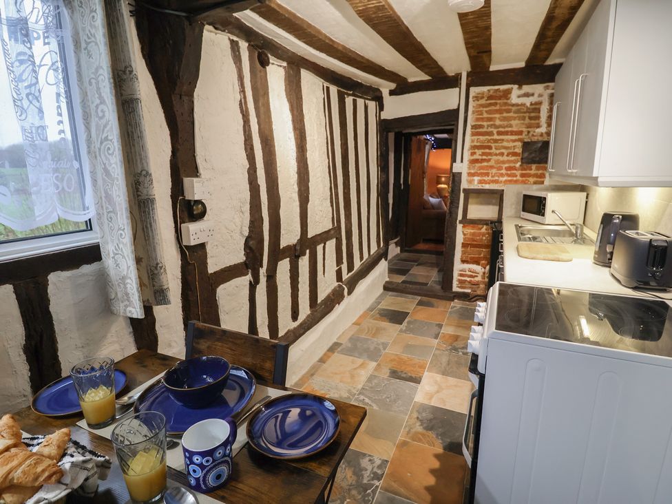 A kitchen with a table set for breakfast at Driftway Cottage in Diss
