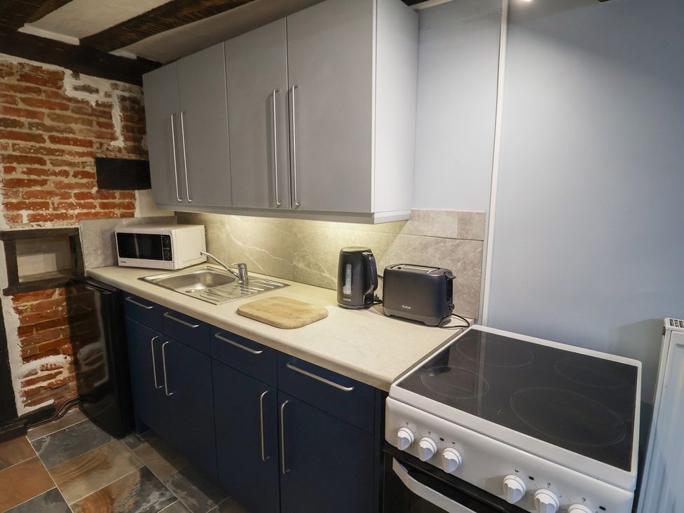 A kitchen with a sink and appliances at Driftway Cottage in Diss