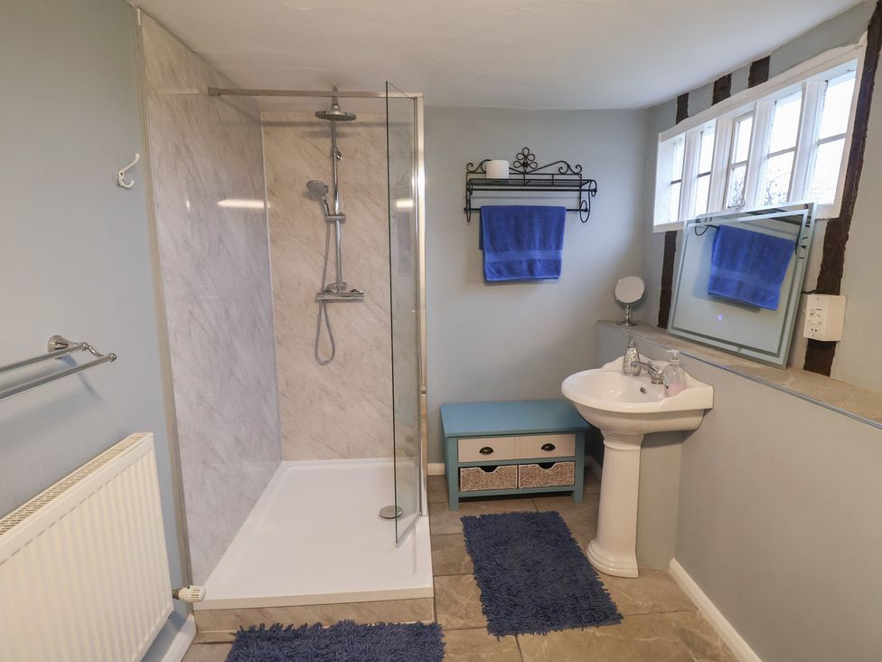A bathroom with a shower and wash basin at Driftway Cottage in Diss