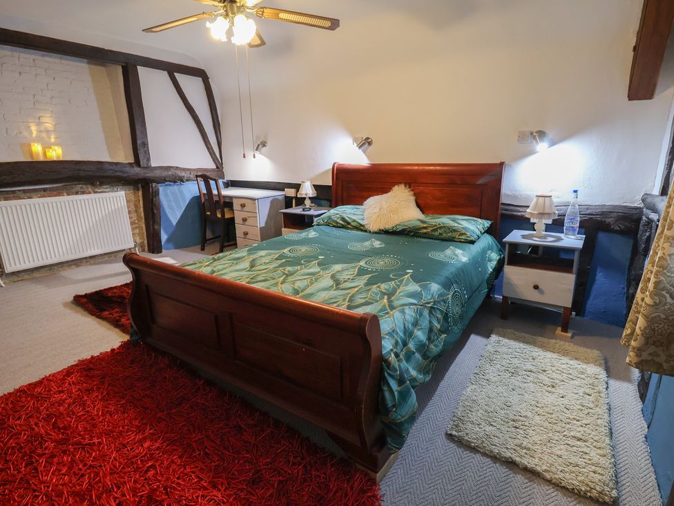 A bedroom with bed and furniture at Driftway Cottage in Diss