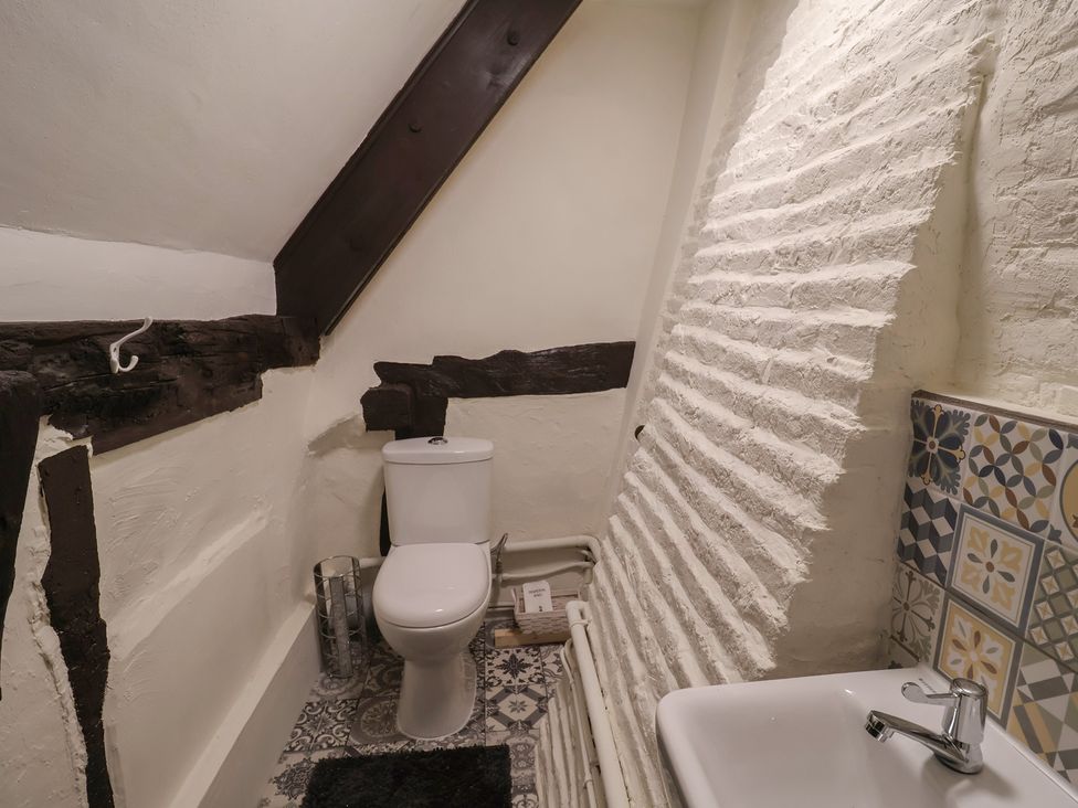A bathroom with a toilet and sink at Driftway Cottage Diss