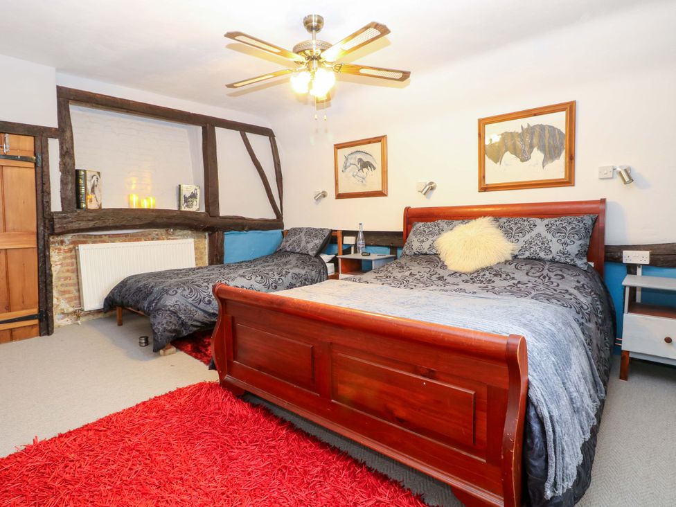 A bedroom with two beds and bedside tables at Driftway Stables Retreat in Diss