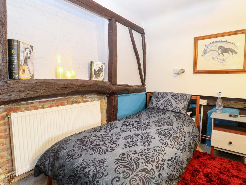 A bedroom with a bed and bedside table at Driftway Stables Retreat in Diss