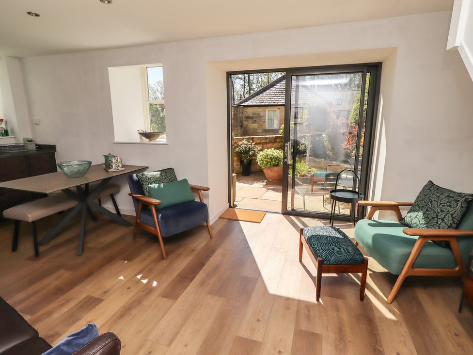 A living room with a table and chairs at Snowdrop Cottage near Warkworth
