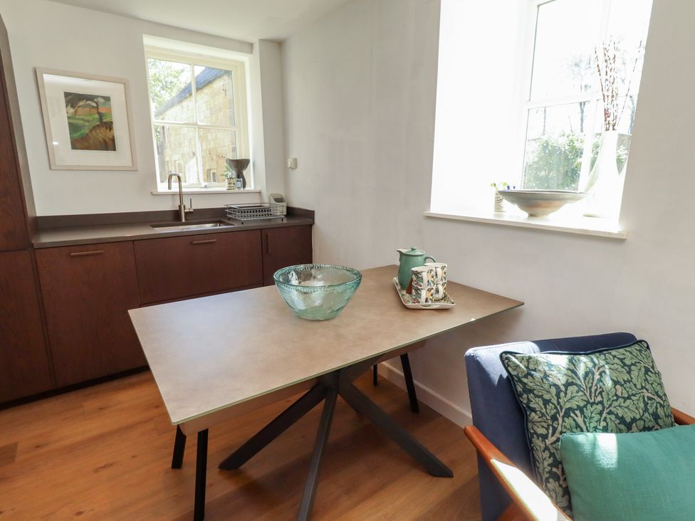 A kitchen with a table and bowl at Snowdrop Cottage near Warkworth