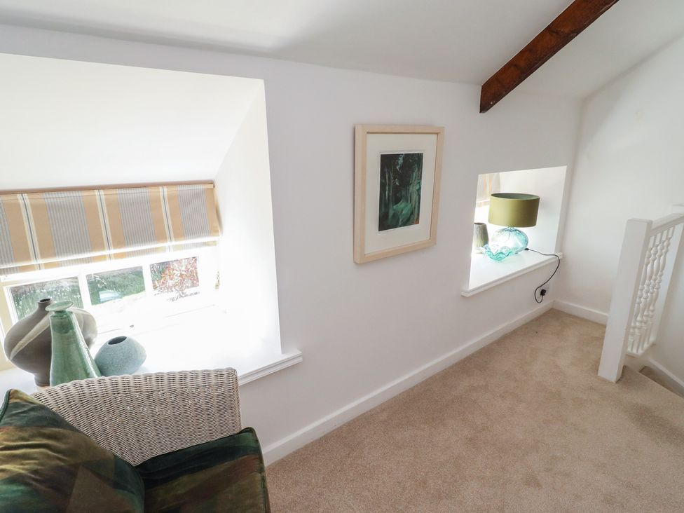 A landing with windows and decorative items at Snowdrop Cottage near Warkworth