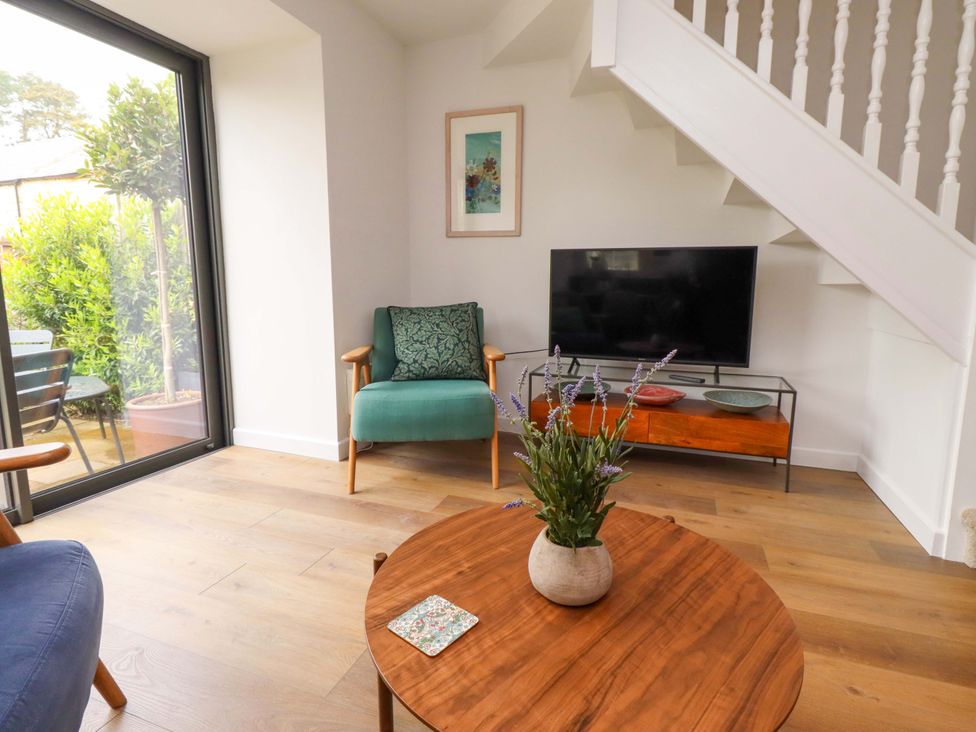 A living room with a chair and television at Snowdrop Cottage near Warkworth