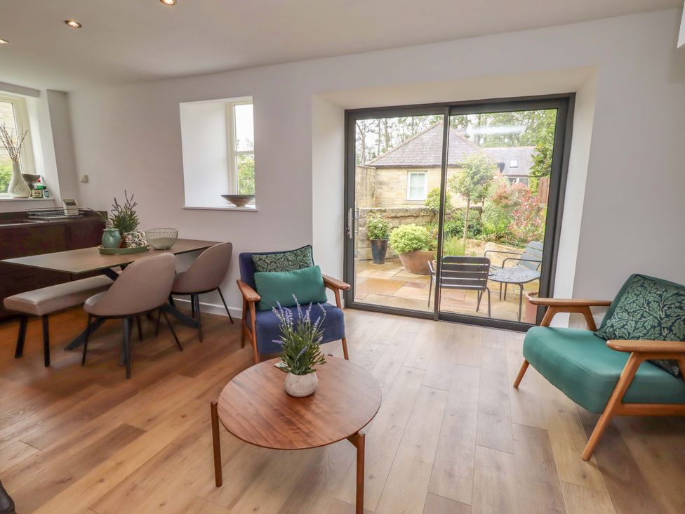 A living room with a table and chairs at Snowdrop Cottage near Warkworth