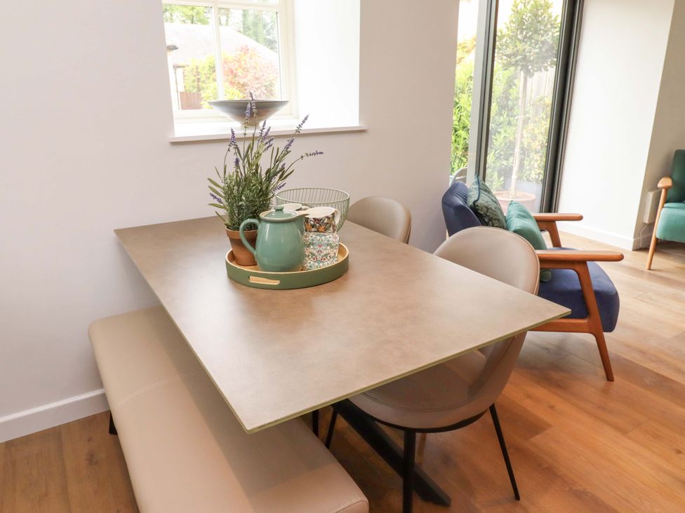 A dining room with a table and chairs at Snowdrop Cottage near Warkworth