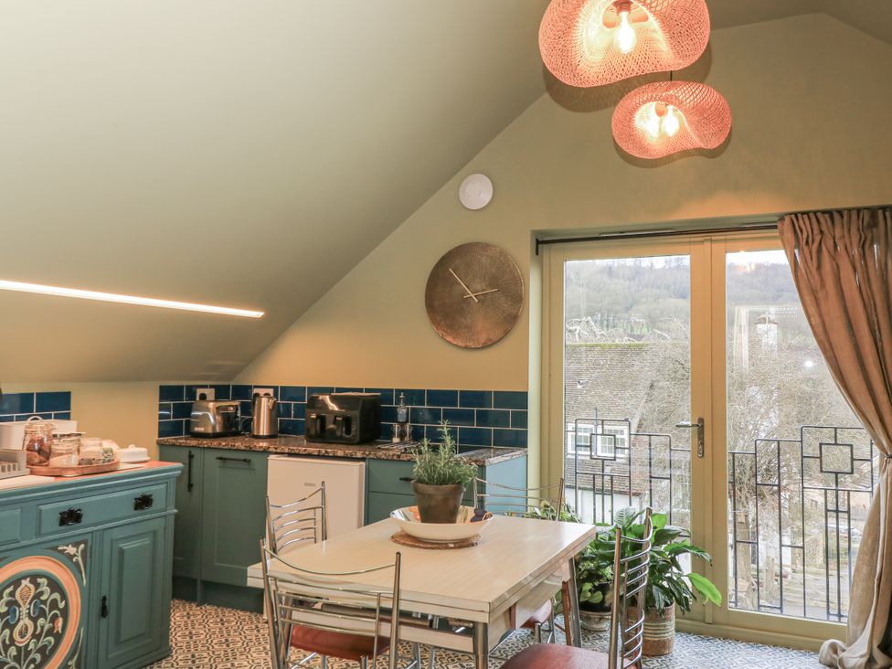 A kitchen with a table and chairs at Golden Valley View in Stroud