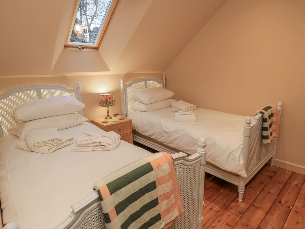 A bedroom with two beds and a window at Golden Valley View, Stroud
