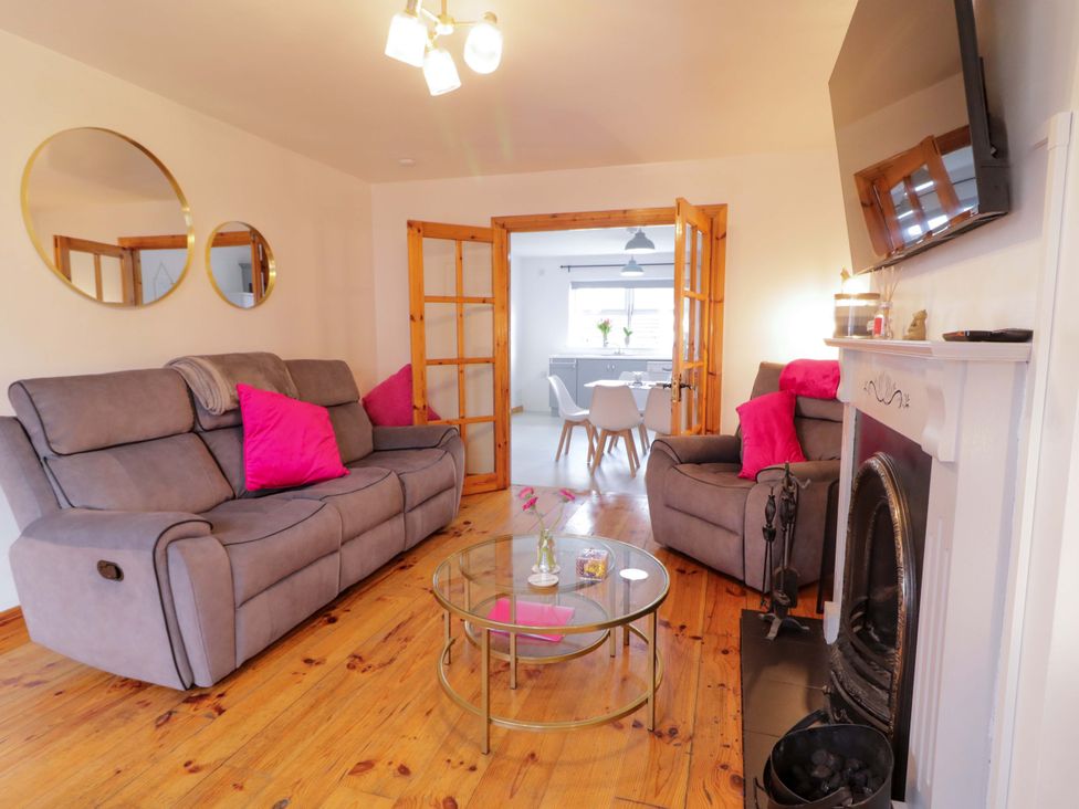 A living room with a sofa and coffee table at Primrose Seaside Escape