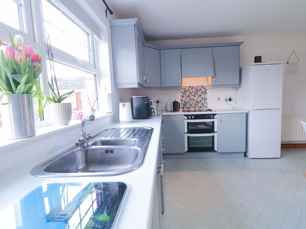 A kitchen with cabinets and appliances at Primrose Seaside Escape