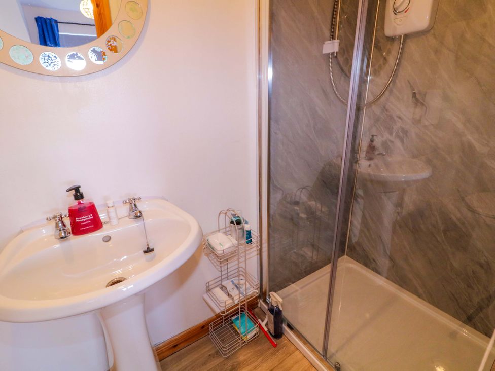 A bathroom with a sink and shower at Primrose Seaside Escape