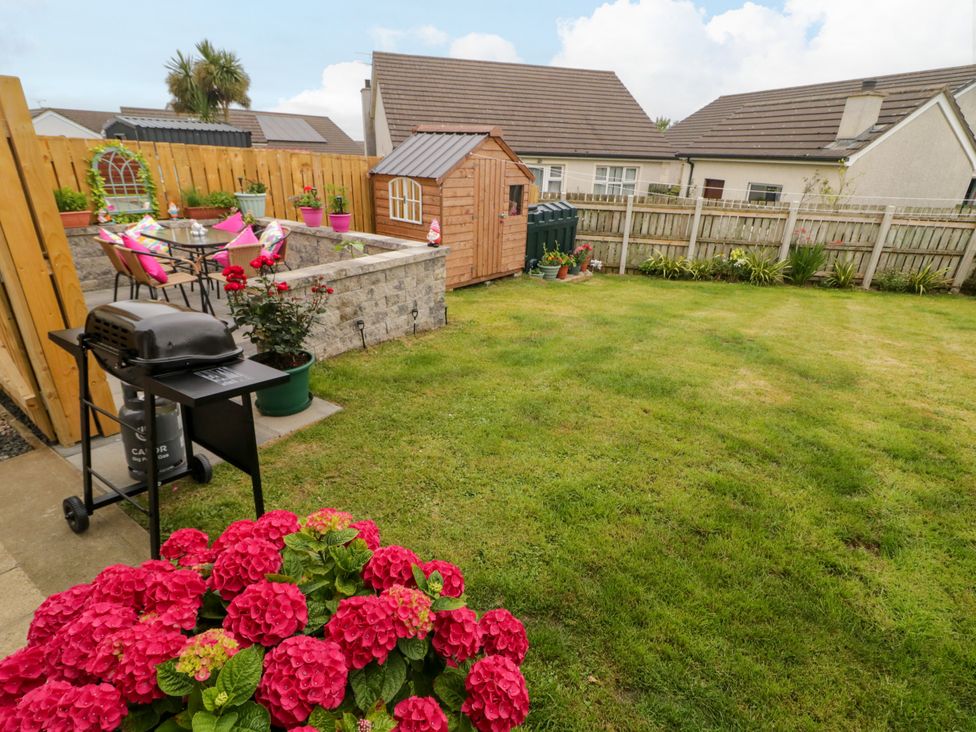 A garden featuring a barbecue grill and a shed at Primrose Seaside Escape, Portrush, County Antrim