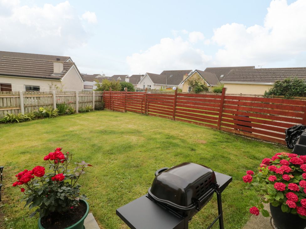 A garden with a grill and flowers at Primrose Seaside Escape in Portrush, County Antrim