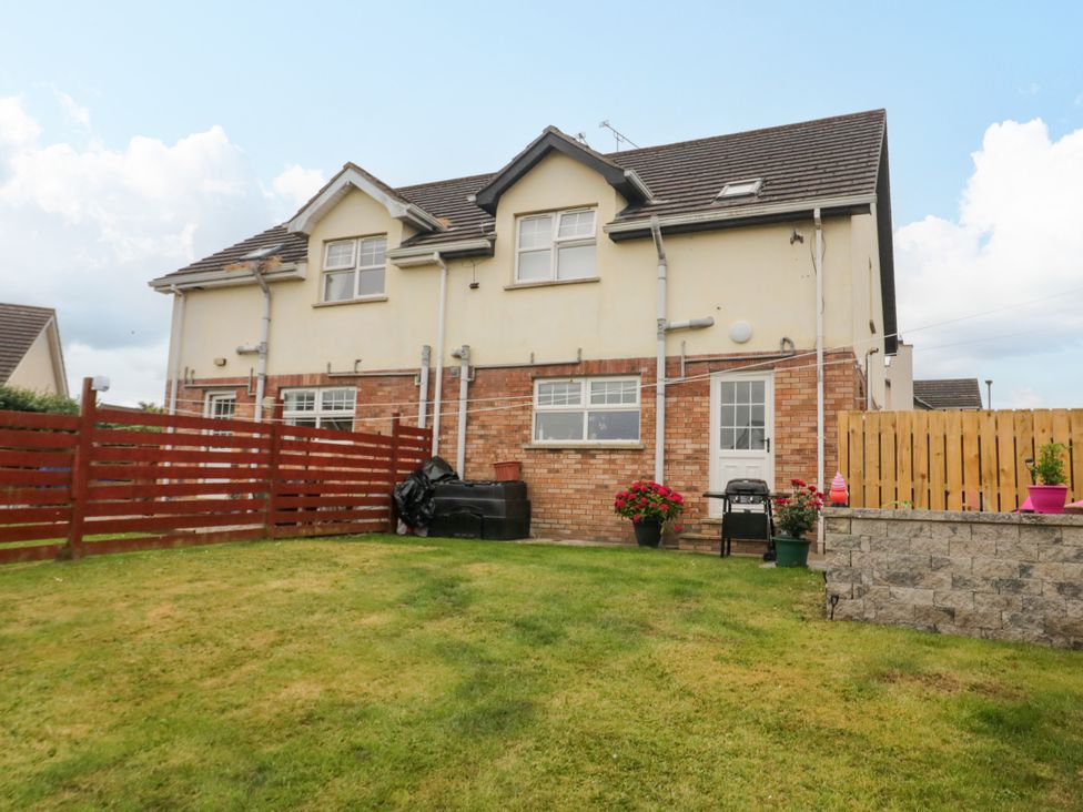 A house with a garden and fence at Primrose Seaside Escape in Portrush, County Antrim