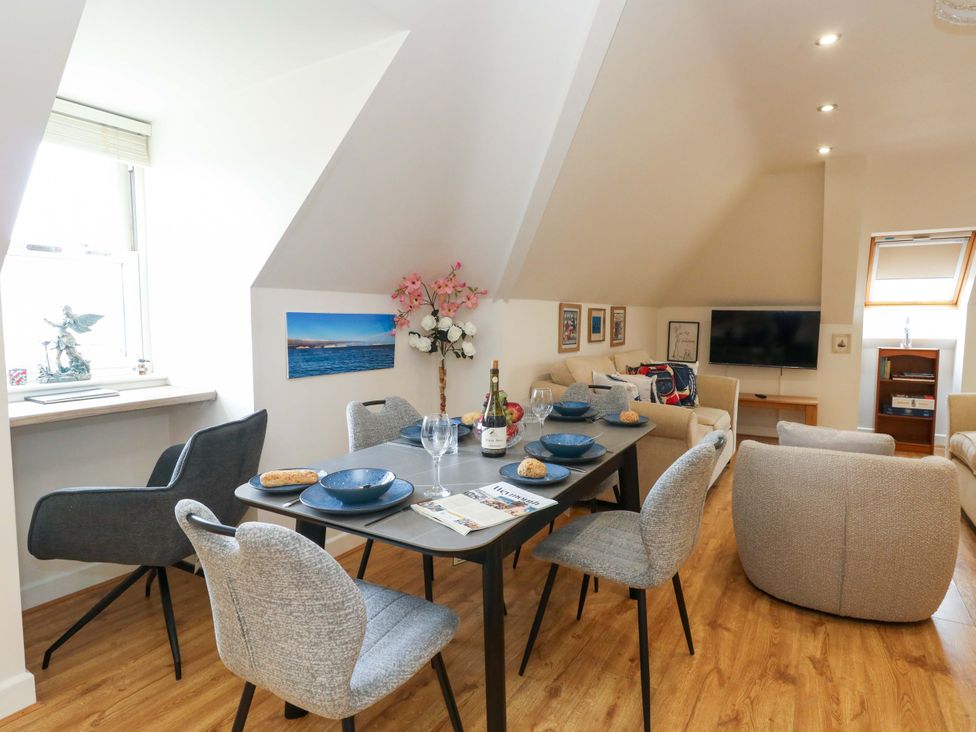 A dining room with a table set for dinner at Flat 7 in Weymouth
