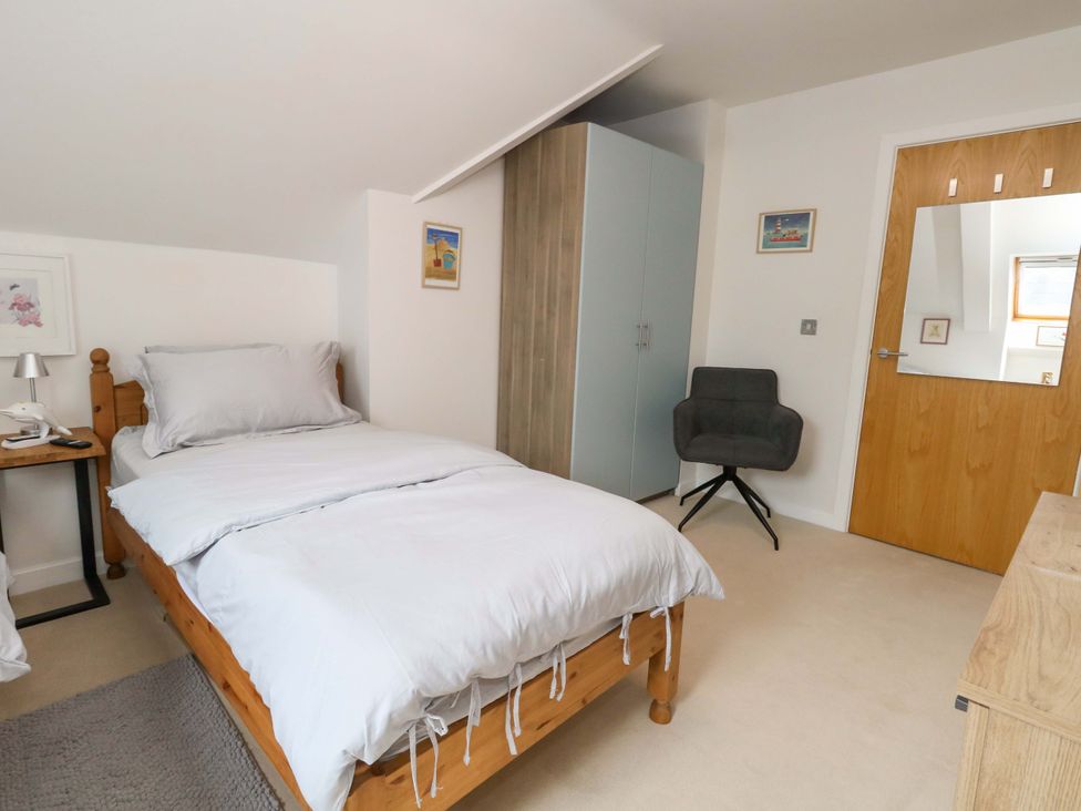 A bedroom with a bed and furniture at Flat 7 Weymouth