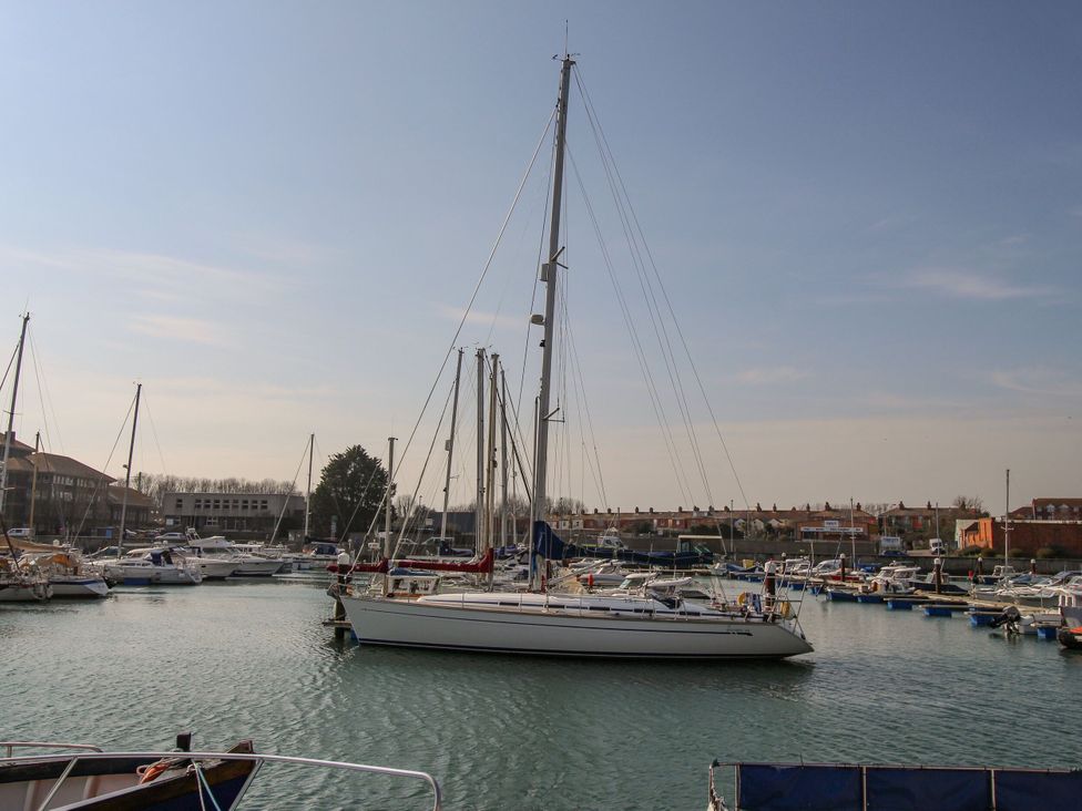 A marina with various boats near the dock at Flat 7 Weymouth