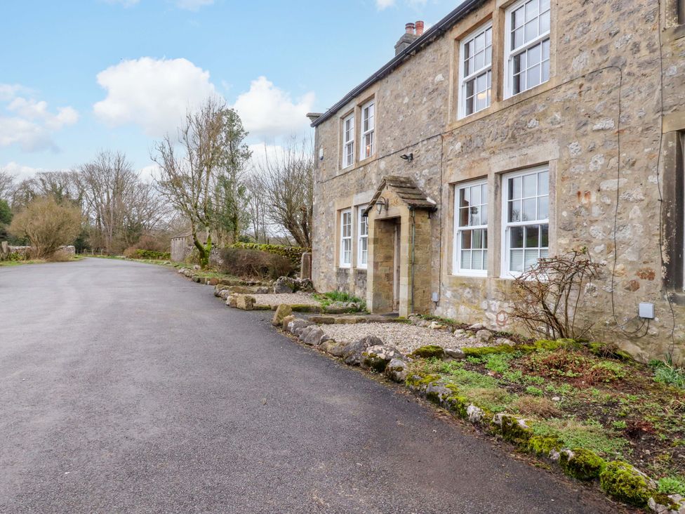 An exterior view of a stone house with a pathway at Kirk Yett Skipton