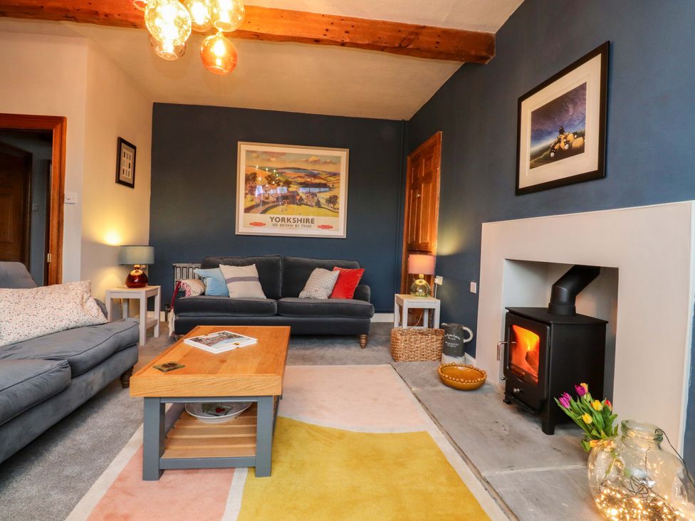 A living room with a sofa and a fireplace at Kirk Yett in Skipton