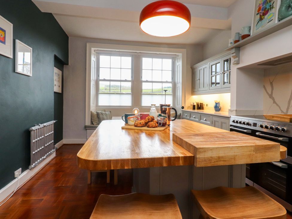 A kitchen with an island and cups on the counter at Kirk Yett in Skipton
