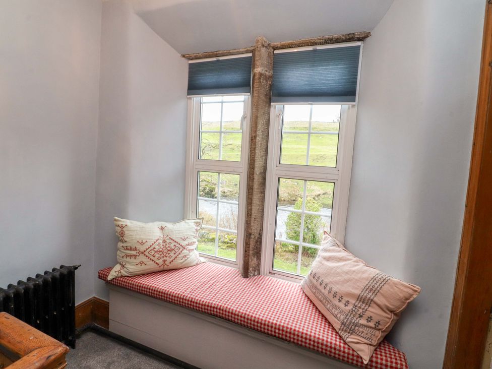 A window seat with cushions and a view at Kirk Yett in Skipton