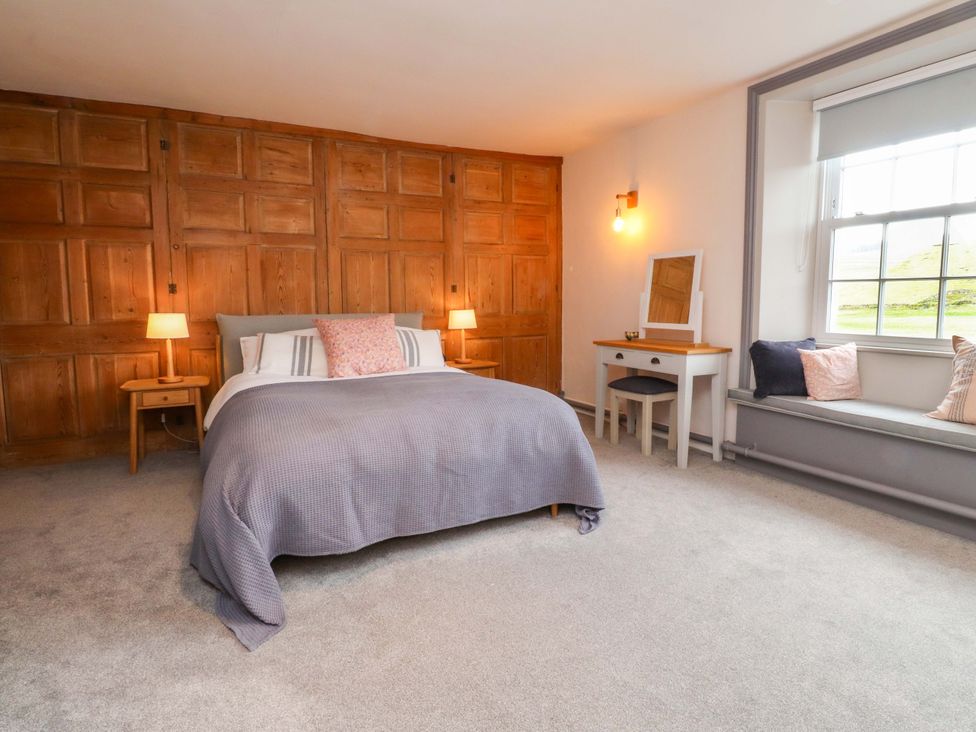 A bedroom with a bed and nightstand at Kirk Yett in Skipton