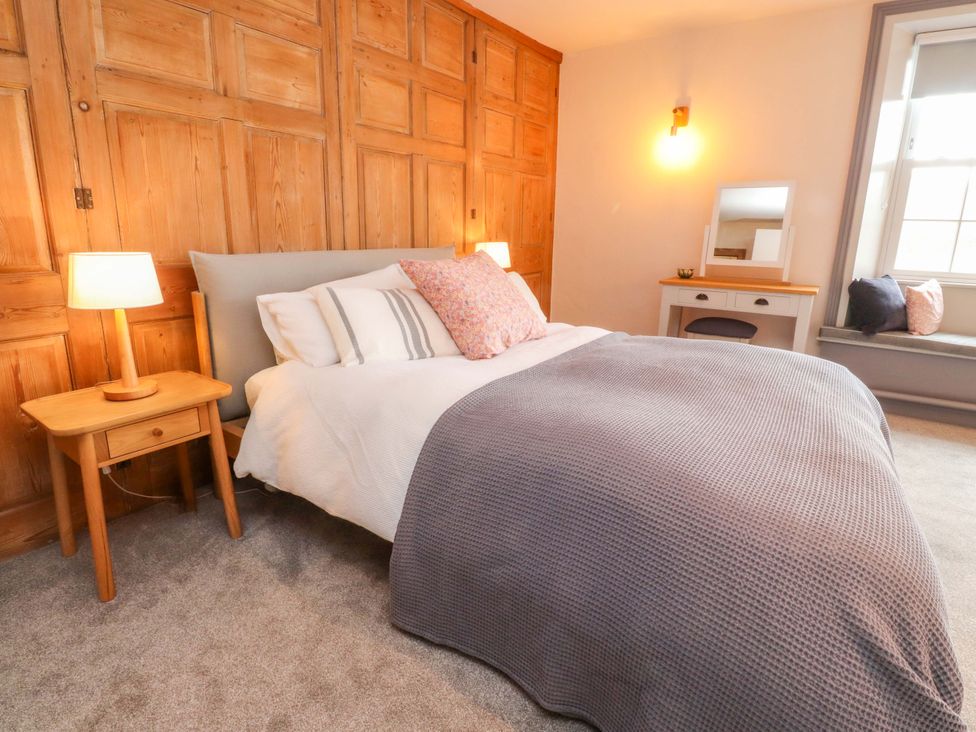 A bedroom with a bed and nightstand at Kirk Yett in Skipton