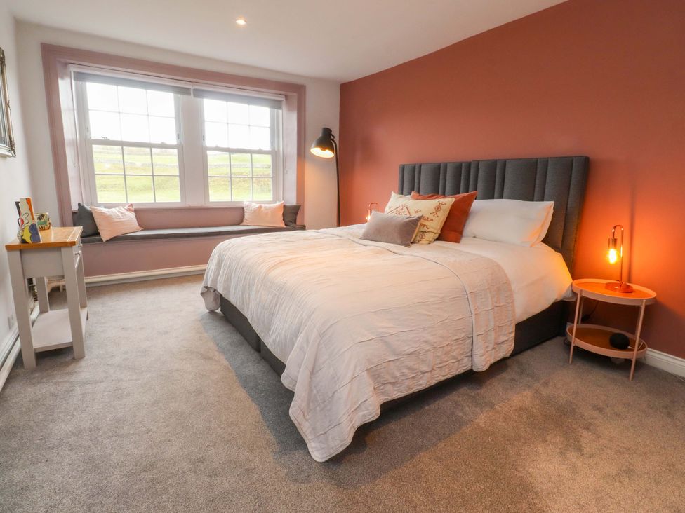 A bedroom with a bed and nightstand at Kirk Yett in Skipton