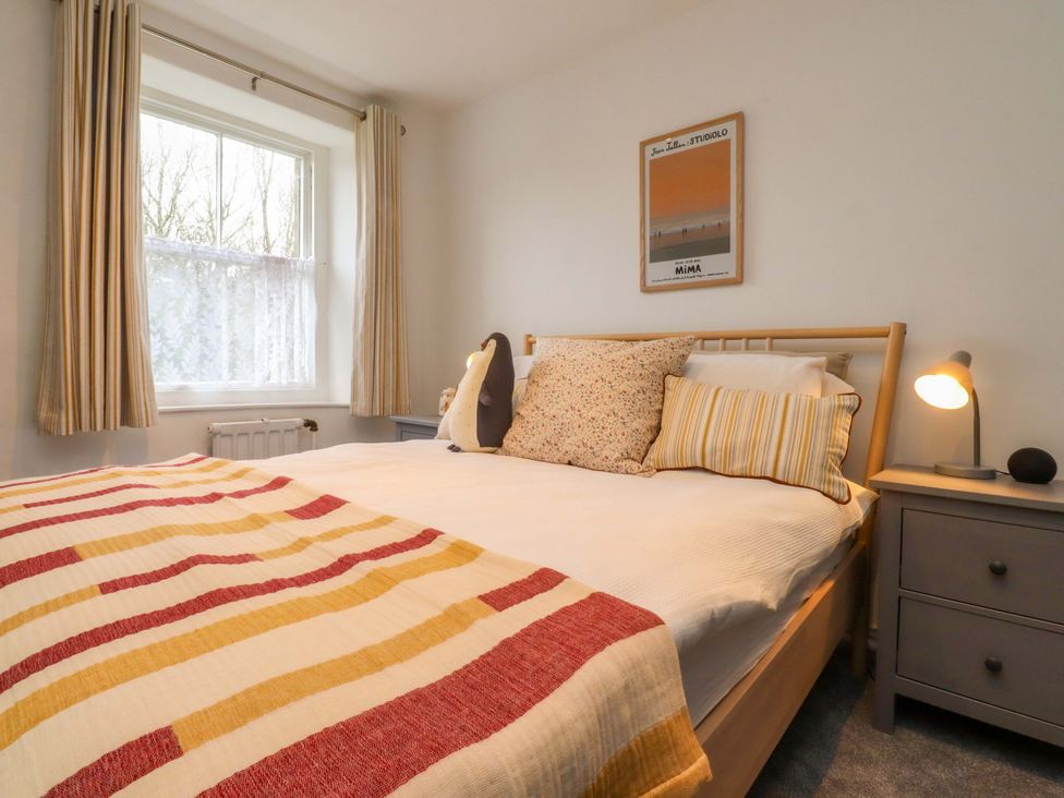 A bedroom with a bed and nightstand at Kirk Yett in Skipton