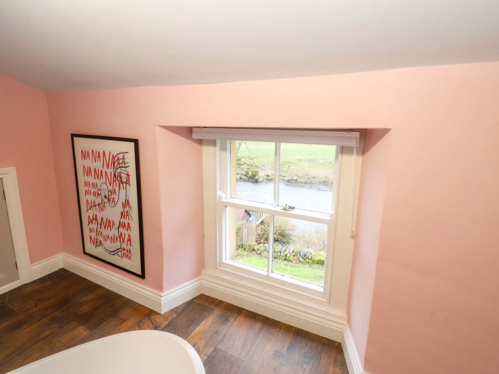 A room with a window and artwork at Kirk Yett in Skipton