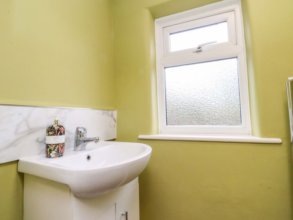 A bathroom with a sink and window at Kirk Yett in Skipton