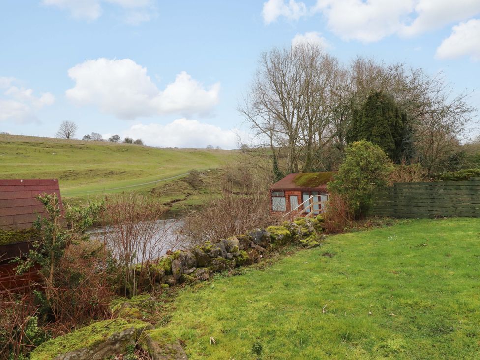 A garden with a shed and water view at Kirk Yett in Skipton