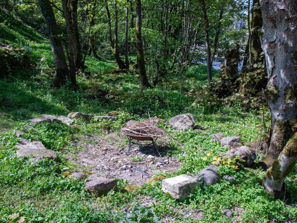 A fire pit surrounded by rocks and grass at Kirk Yett in Linton Falls near Skipton