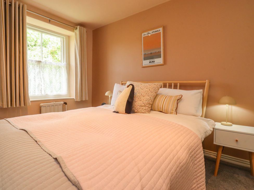 A bedroom with a bed, window, and a nightstand at Kirk Yett in Linton Falls near Skipton
