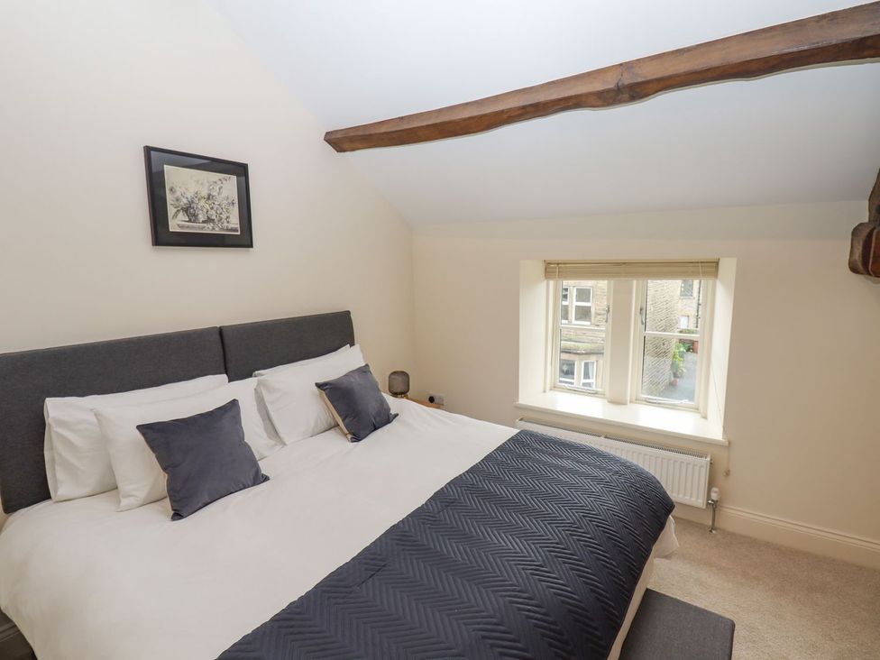 A bedroom with a bed and window at 1 Grosvenor Farm Cottages Skipton