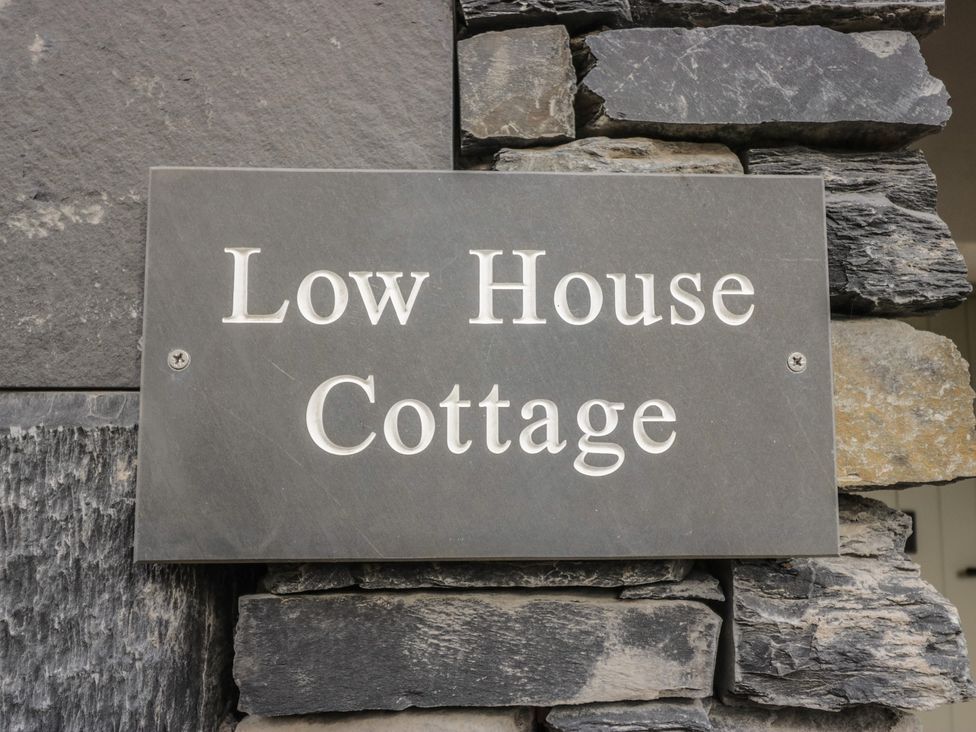 A nameplate on a stone wall at Low House Cottage in Ayside near Newby Bridge