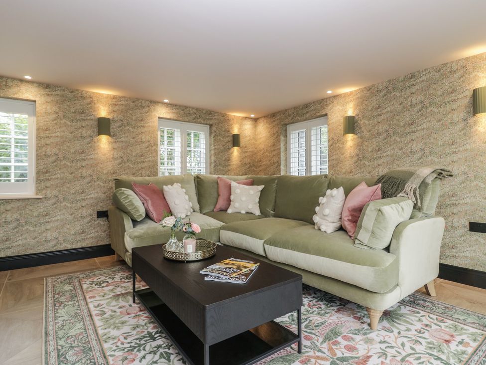 A living room with a green sofa and coffee table at Low House Cottage Ayside near Newby Bridge