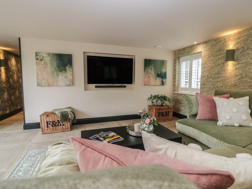 A living room with a television and seating area at Low House Cottage Ayside near Newby Bridge