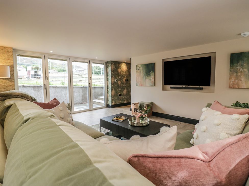 A living room with a sofa and coffee table at Low House Cottage Ayside near Newby Bridge
