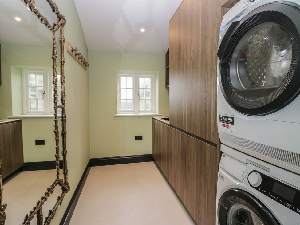 A laundry room with a washing machine and tumble dryer at Low House Cottage Ayside near Newby Bridge