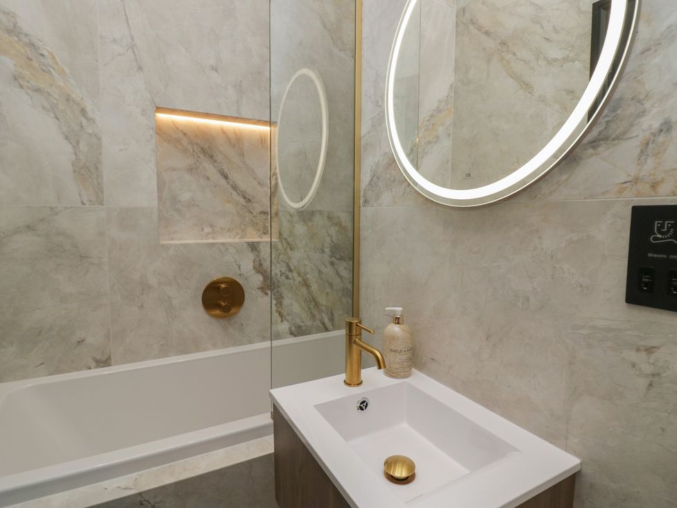A bathroom with a bathtub and sink at Low House Cottage Ayside near Newby Bridge
