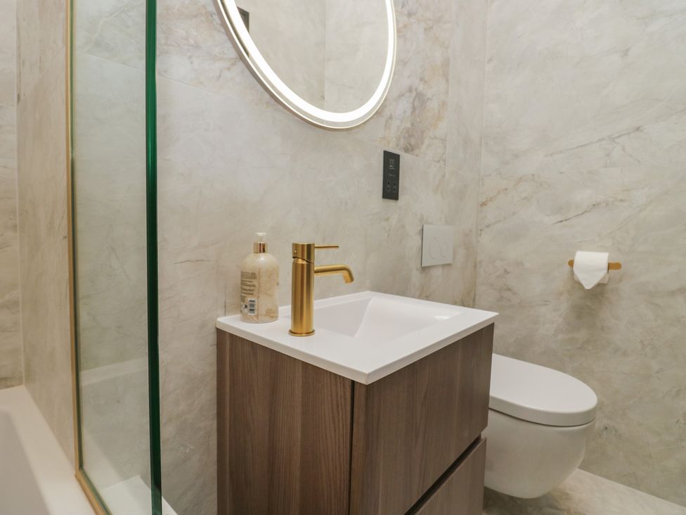 A bathroom with a sink, toilet, and shower at Low House Cottage Ayside near Newby Bridge