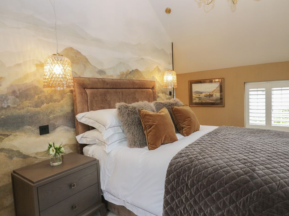 A bedroom with a bed and bedside table at Low House Cottage Ayside near Newby Bridge
