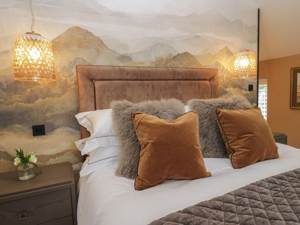 A bedroom with a bed and lamps at Low House Cottage Ayside near Newby Bridge