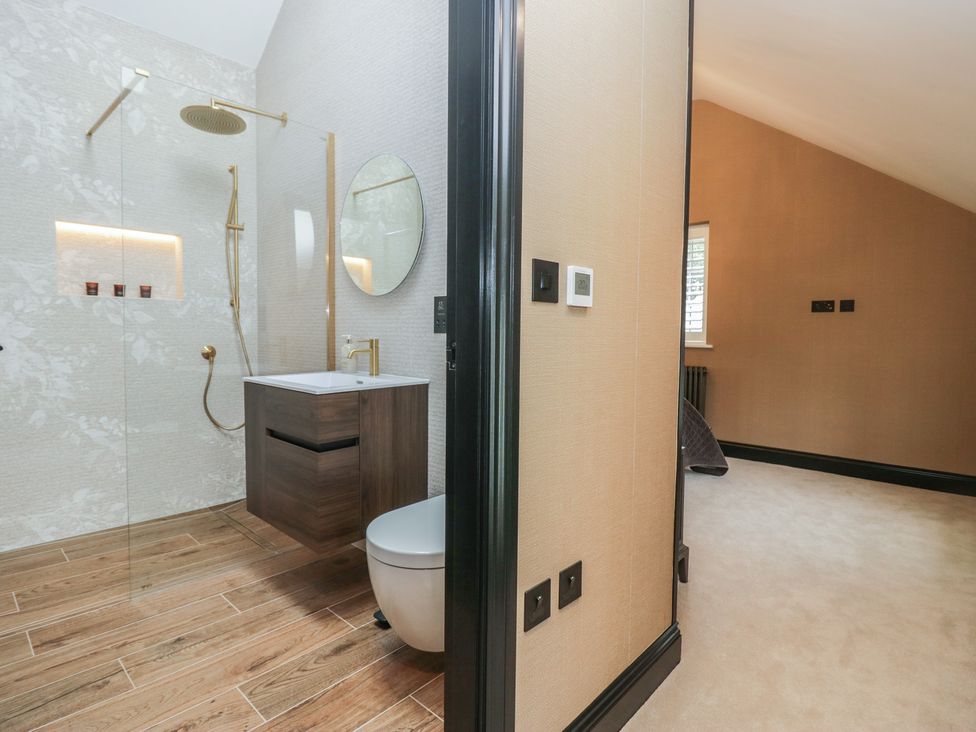 A bathroom with a shower and toilet visible at Low House Cottage Ayside near Newby Bridge