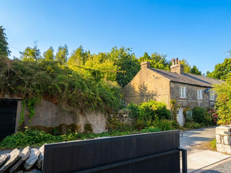 A house with a garden and gate at Low House Cottage in Ayside near Newby Bridge