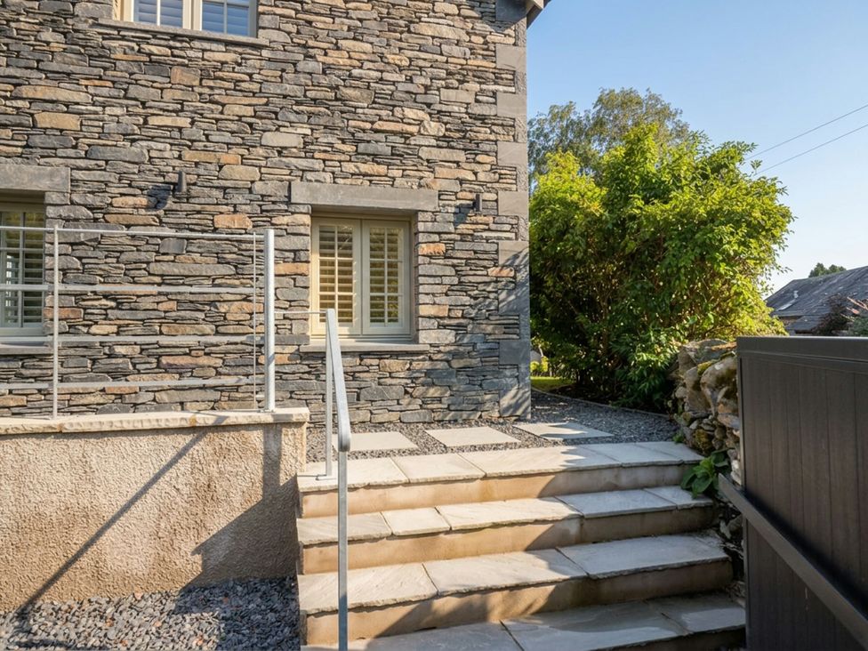 A stone exterior with steps and plants at Low House Cottage Ayside near Newby Bridge
